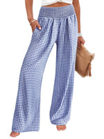 Blue and white checkered pants worn by a person on a white background