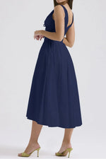 Navy blue dress worn by a person on a white background