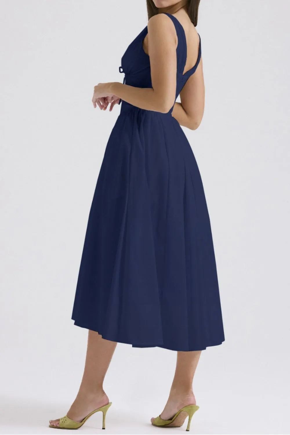 Navy blue dress worn by a person on a white background