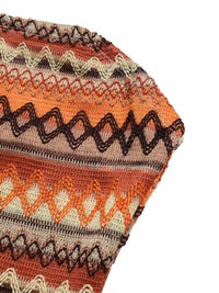 Close-up of a knitted fabric with a colorful pattern on a white background