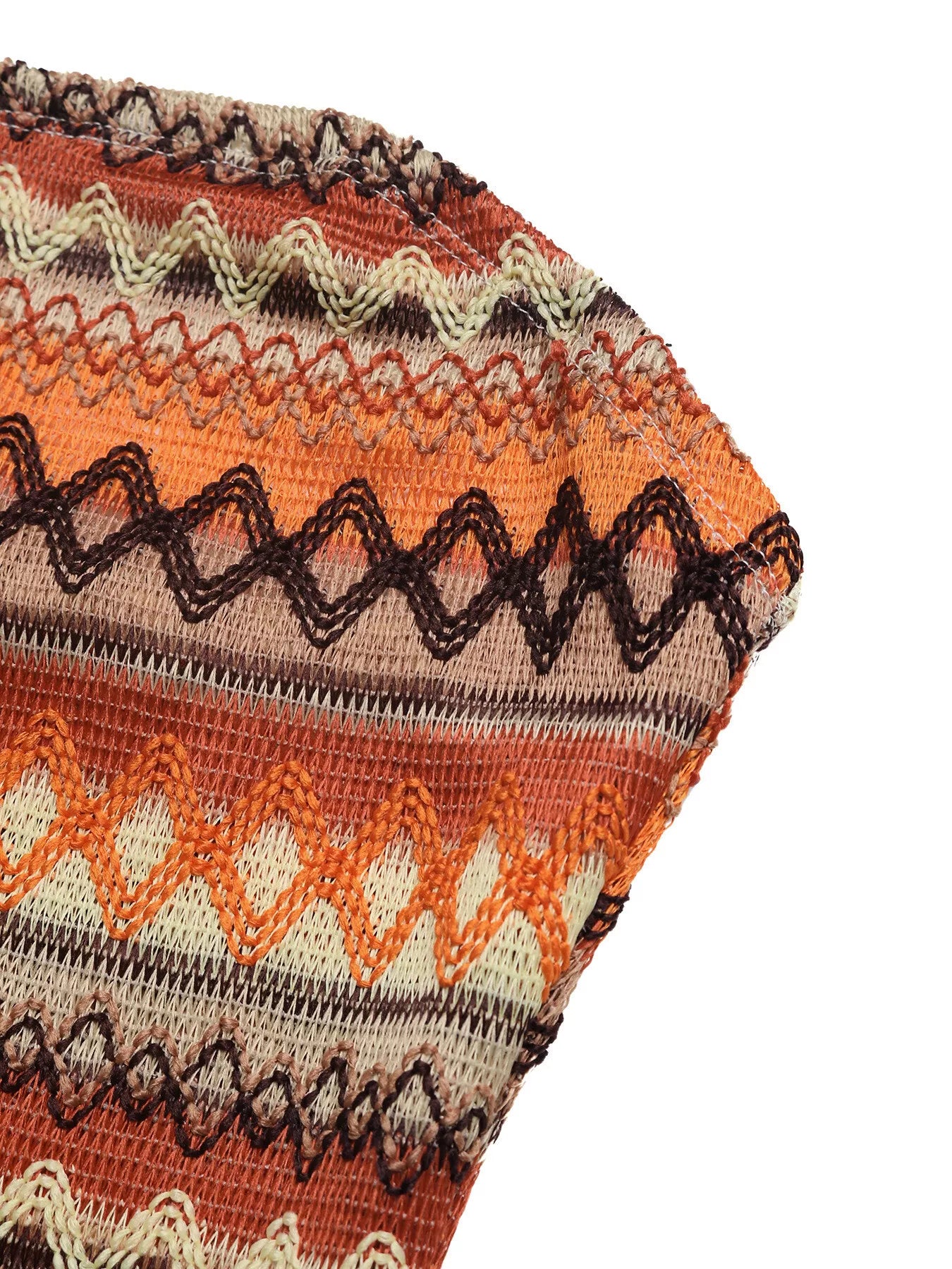 Close-up of a knitted fabric with a colorful pattern on a white background