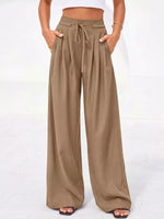 Beige wide-leg pants worn by a person on a white background