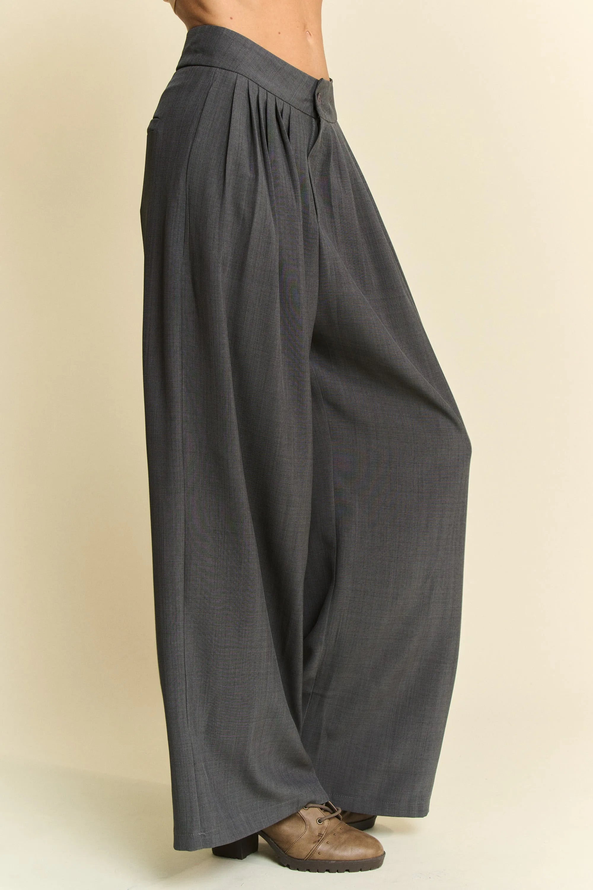 Dark gray wide-leg pants on a beige background