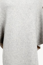 Close-up of a textured gray sweater on a white background