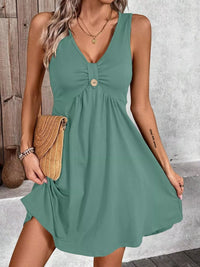 Woman wearing a green dress with a wooden background