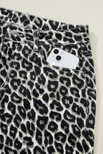 Leopard print pants with a close-up of the waistband on a light background