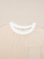 Close-up of a beige striped shirt with a white collar on a beige background