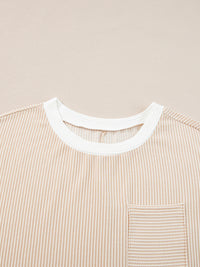 Close-up of a beige striped shirt with a white collar on a beige background