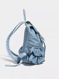 Light blue backpack with ruffled details on a white background