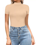 Person wearing a beige short-sleeve top and blue jeans on a white background