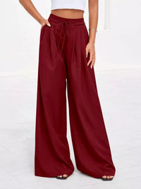 Maroon wide-leg pants worn by a person on a white background