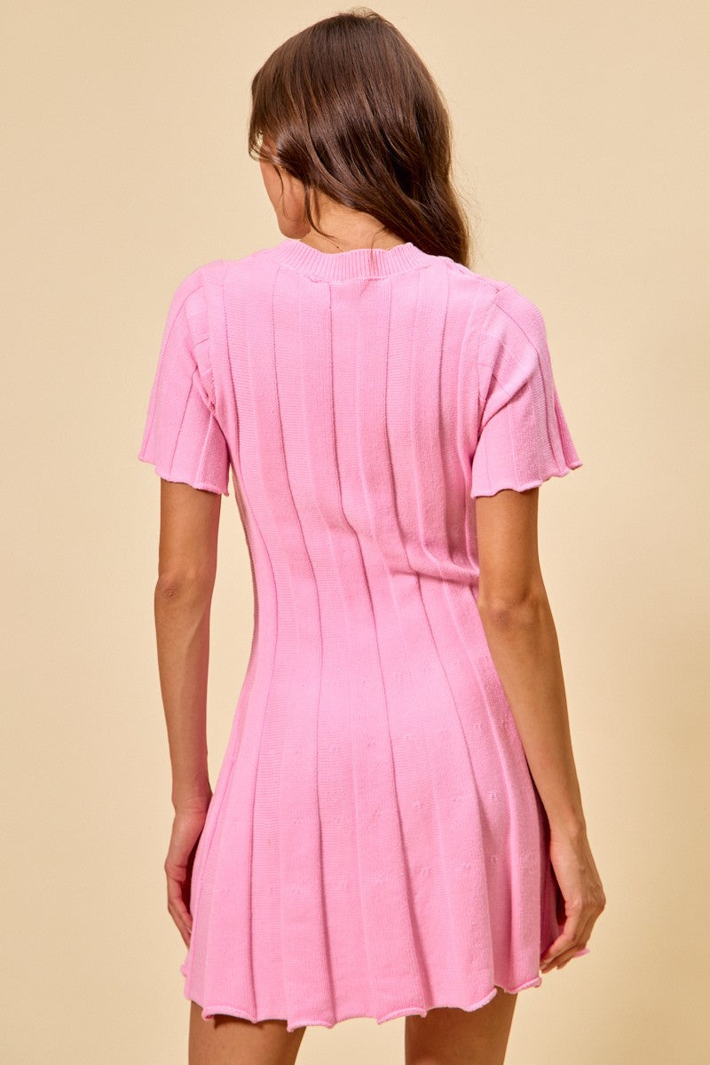 Woman wearing a pink dress against a beige background