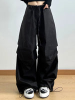 Black wide-leg pants worn by a person on a plain background