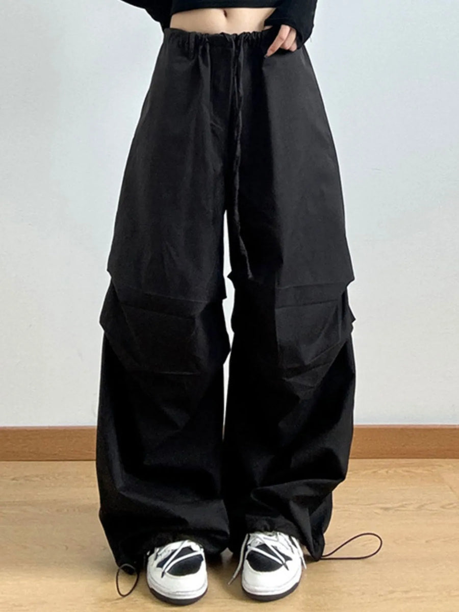 Black wide-leg pants worn by a person on a plain background