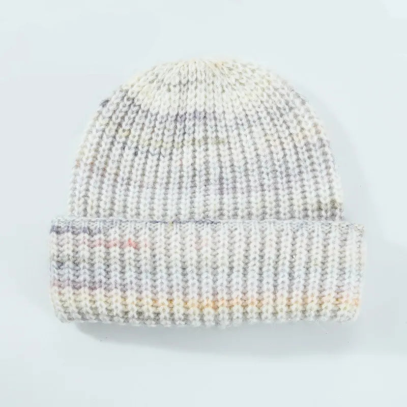 Knitted beanie with multicolor pattern on a light gray background