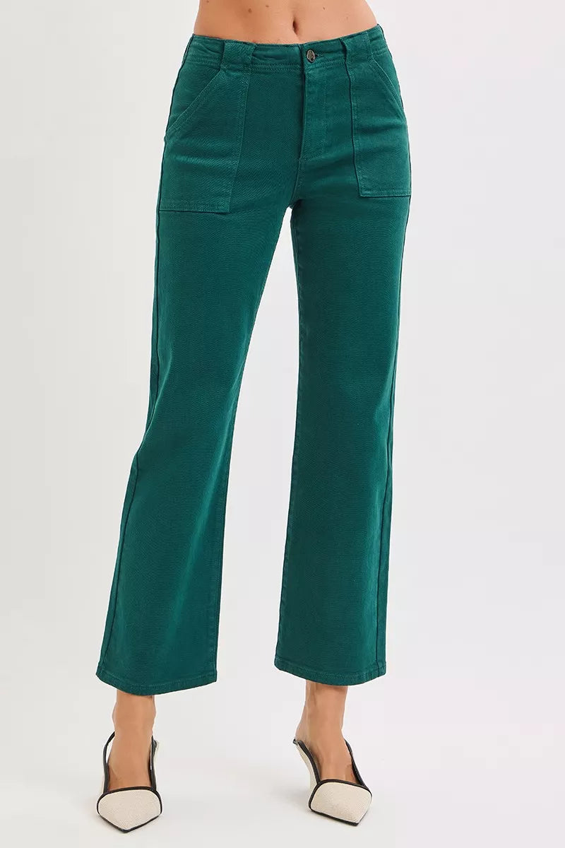 Green pants worn by a person on a white background