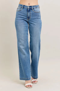 Blue jeans worn by a person on a beige background
