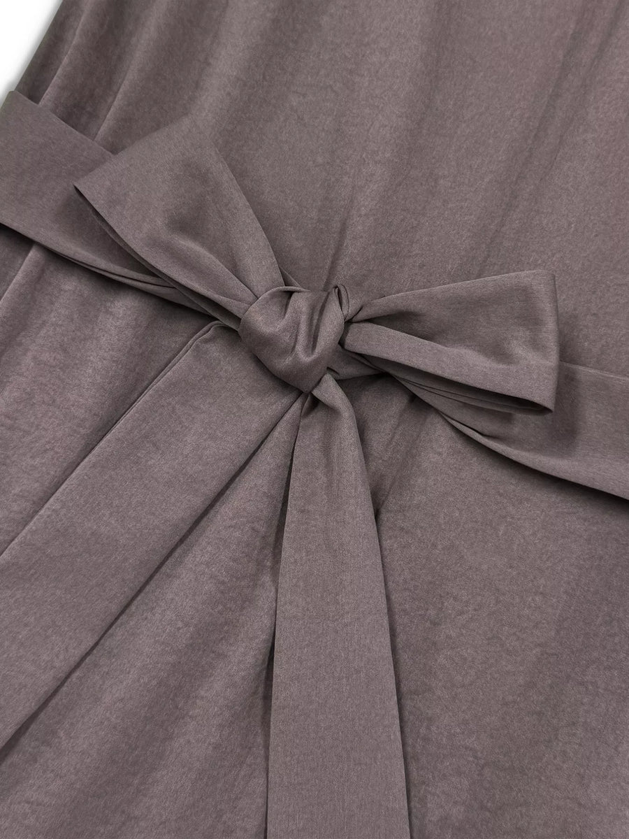 Close-up of a gray dress with a tied bow detail.