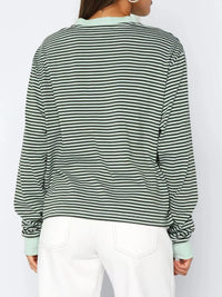 Green and black striped shirt worn by a person on a white background