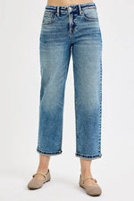 Blue jeans worn by a person on a white background