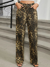 Leopard print pants worn by a person on a staircase.