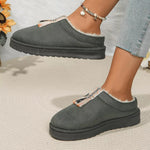Gray slip-on shoes with white lining worn by a person on a neutral background