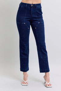 Blue jeans worn by a person on a plain background