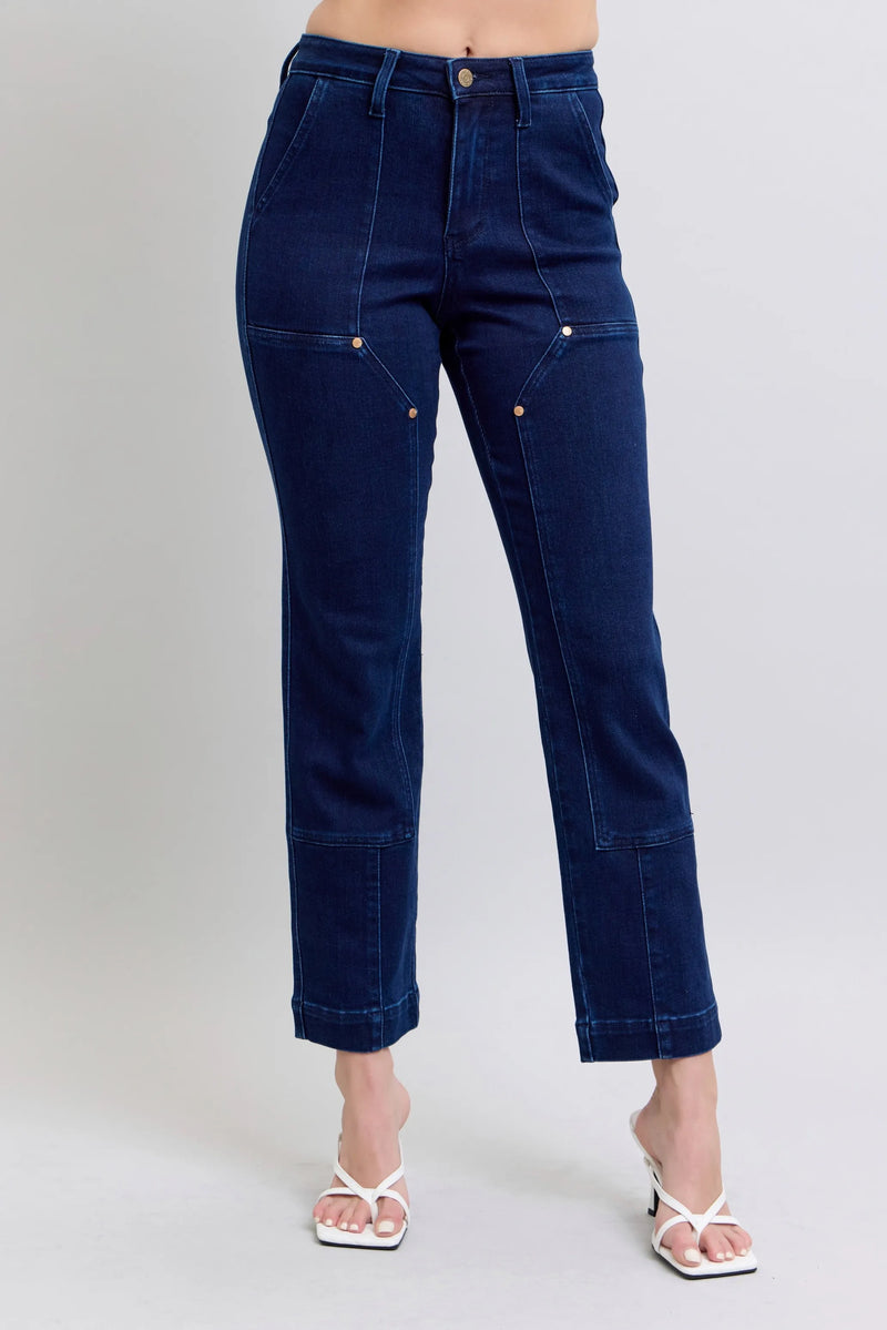 Blue jeans worn by a person on a plain background