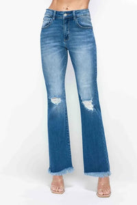 Blue jeans with frayed hem on a white background