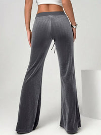 Gray wide-leg pants worn by a person on a white background