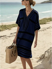 woman wearing a navy and black striped dress