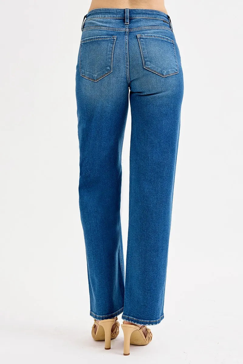 Blue jeans worn by a person on a white background