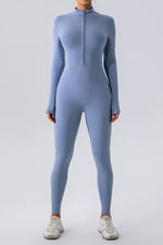 Person wearing a light blue full-body suit on a white background