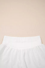 White pants on a beige background