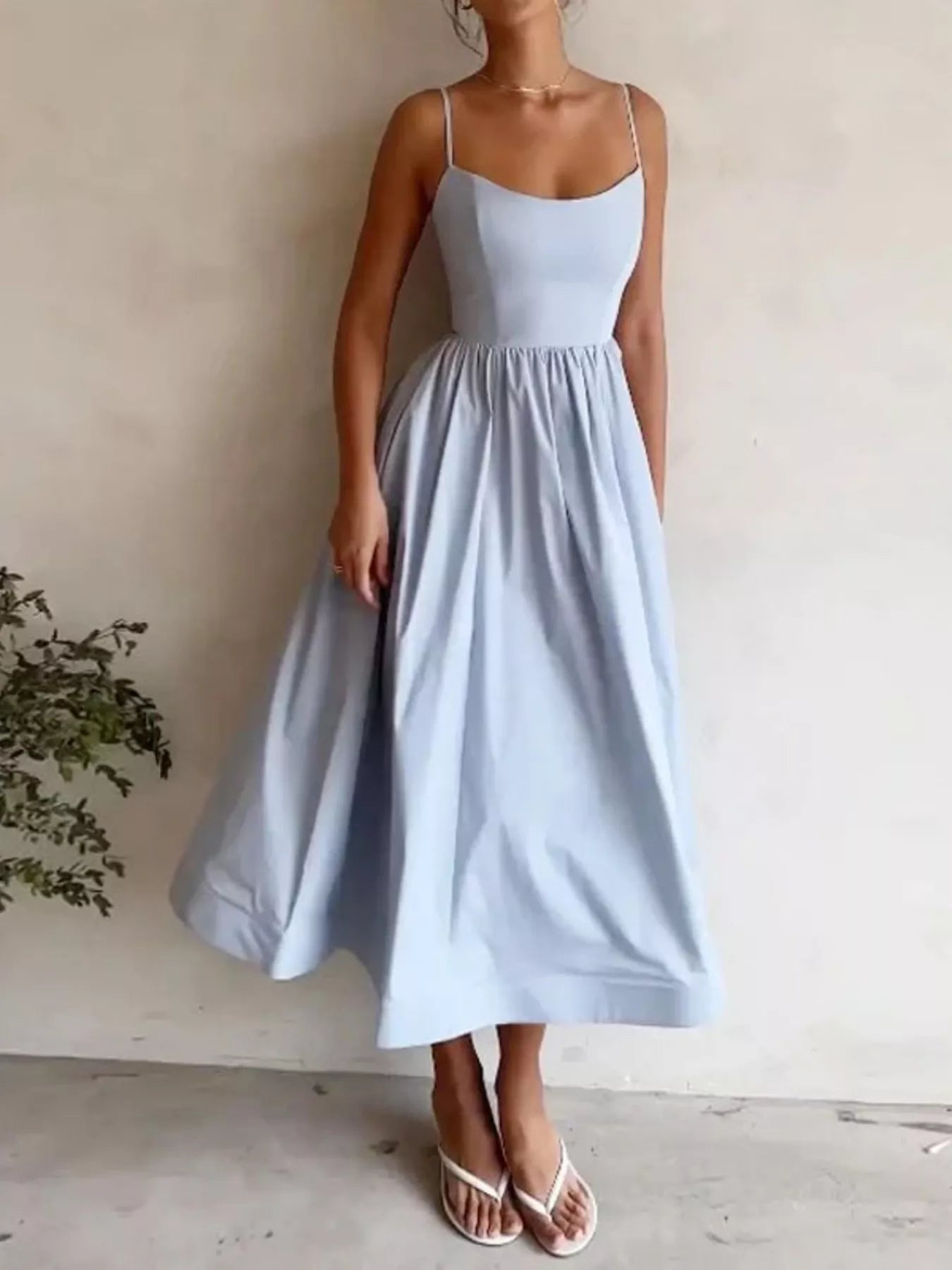Light blue dress worn by a person against a plain background