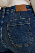 Close-up of blue jeans with a Judy Blue label on the back pocket.