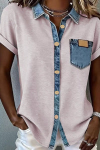 Pink shirt with denim collar and pocket worn by a person against a gray background