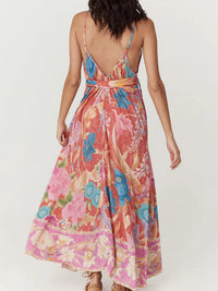 Woman wearing a colorful floral dress on a white background