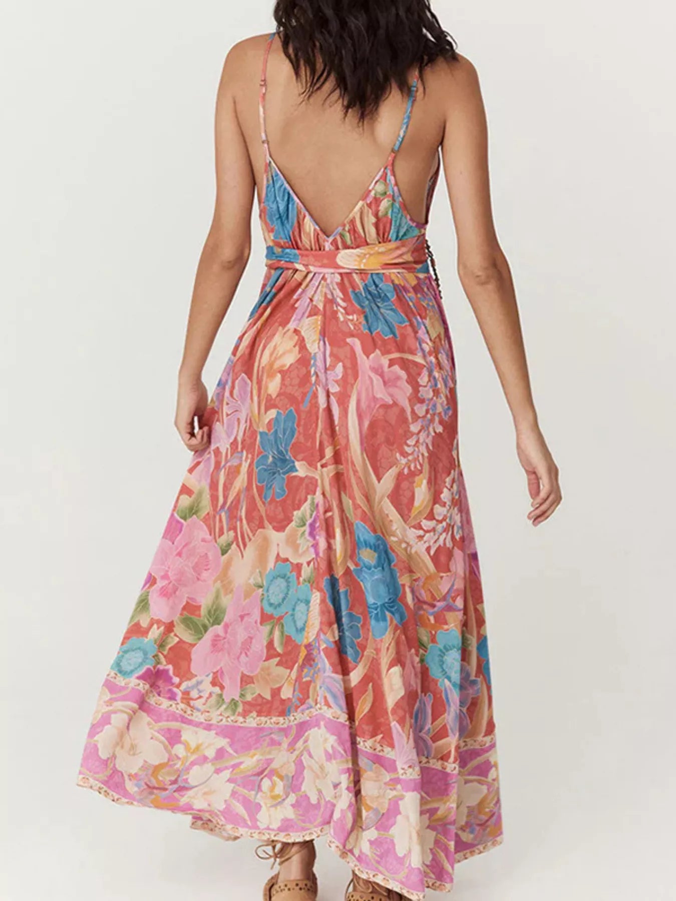 Woman wearing a colorful floral dress on a white background