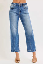 Blue jeans worn by a person on a white background