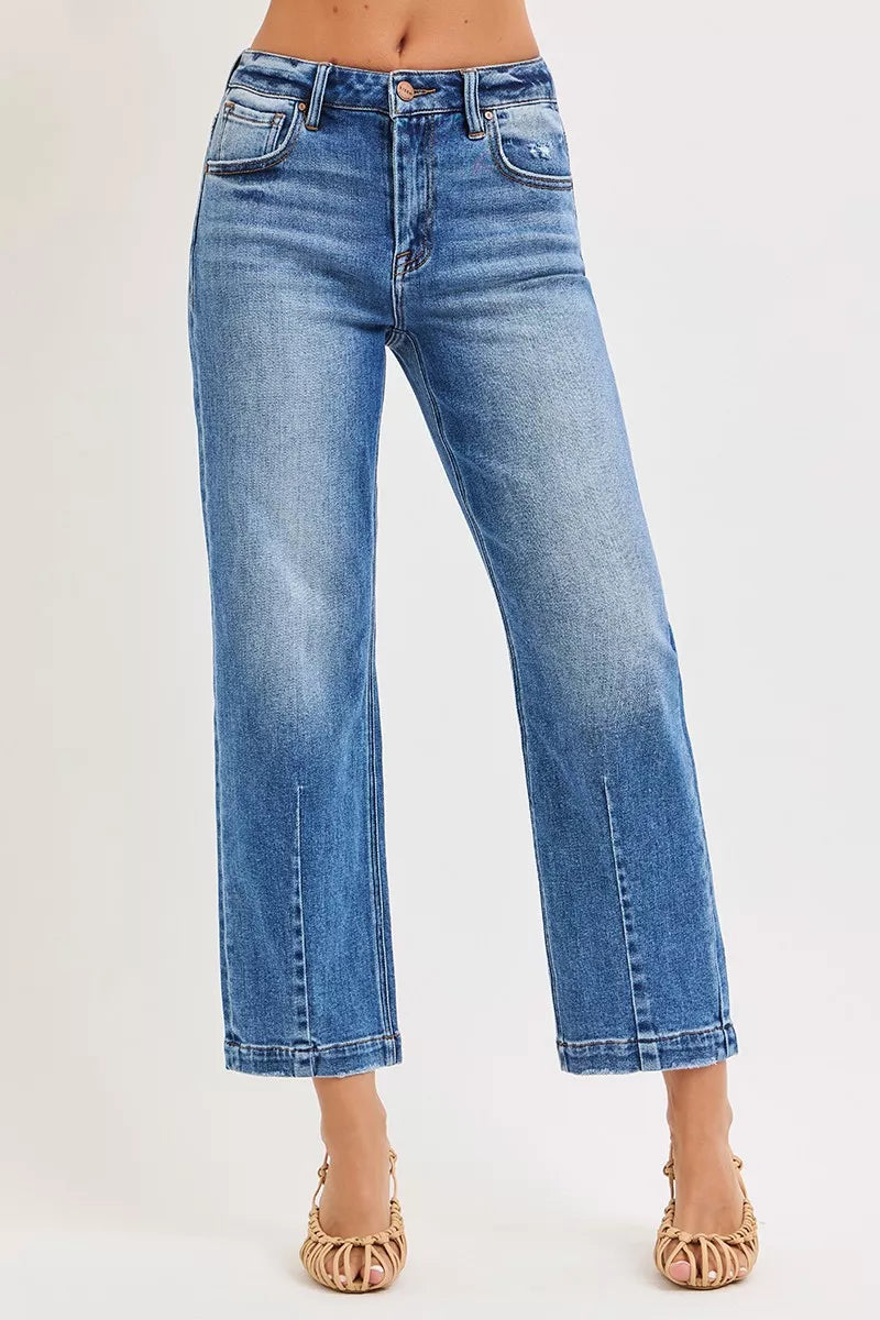 Blue jeans worn by a person on a white background