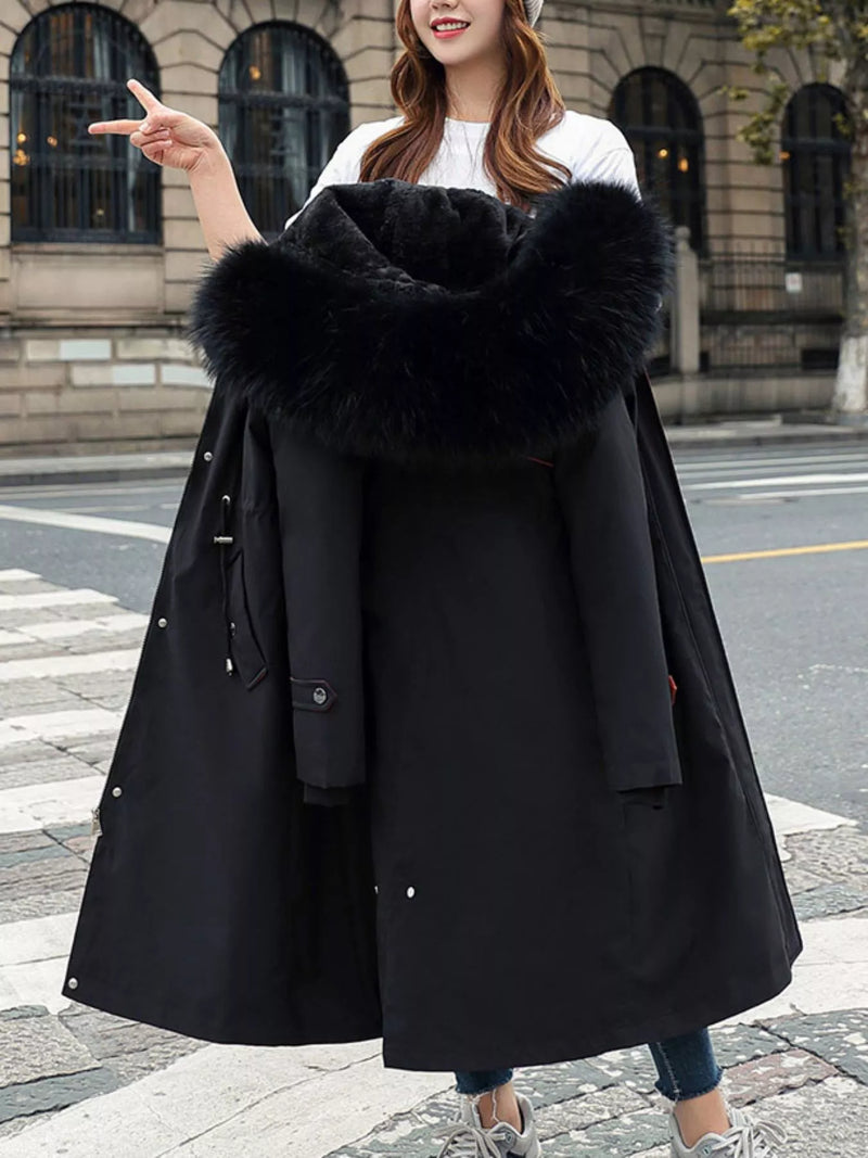 woman holding black Women's Detachable Longline Hooded Parka with Faux Fur Trim and Drawstring Waist in her hand