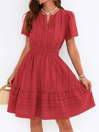 Red dress worn by a person on a white background