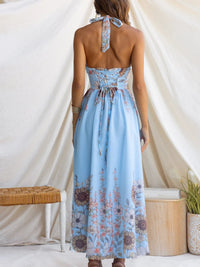 Woman wearing a light blue floral dress with a white background