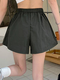 Person wearing black shorts in an indoor setting