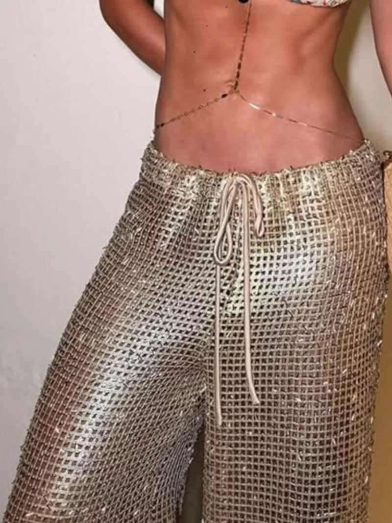 Person wearing sparkly gold pants with a plain background