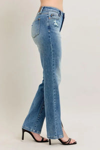 Light blue jeans worn by a person on a plain background
