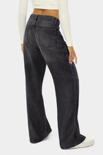 Person wearing black wide-leg jeans on a white background