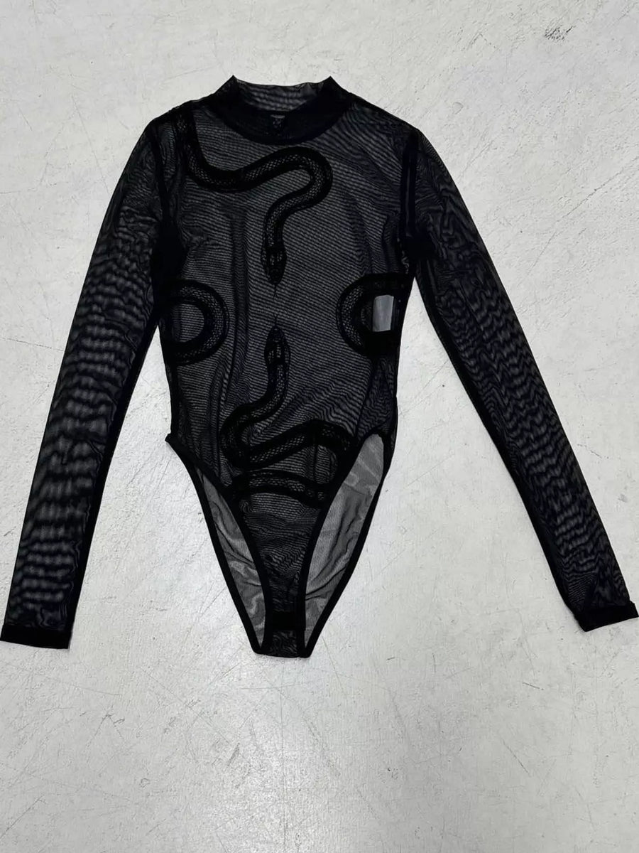A black long-sleeve sheer mesh bodysuit with a snake graphic print, laid flat on a light gray textured surface.