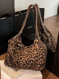 Leopard print handbag on a wooden surface with a blurred background